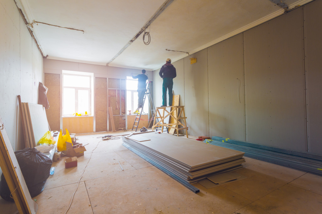 workers renovating a house room