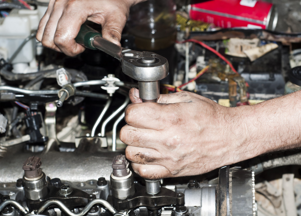 A worker repairing an engine