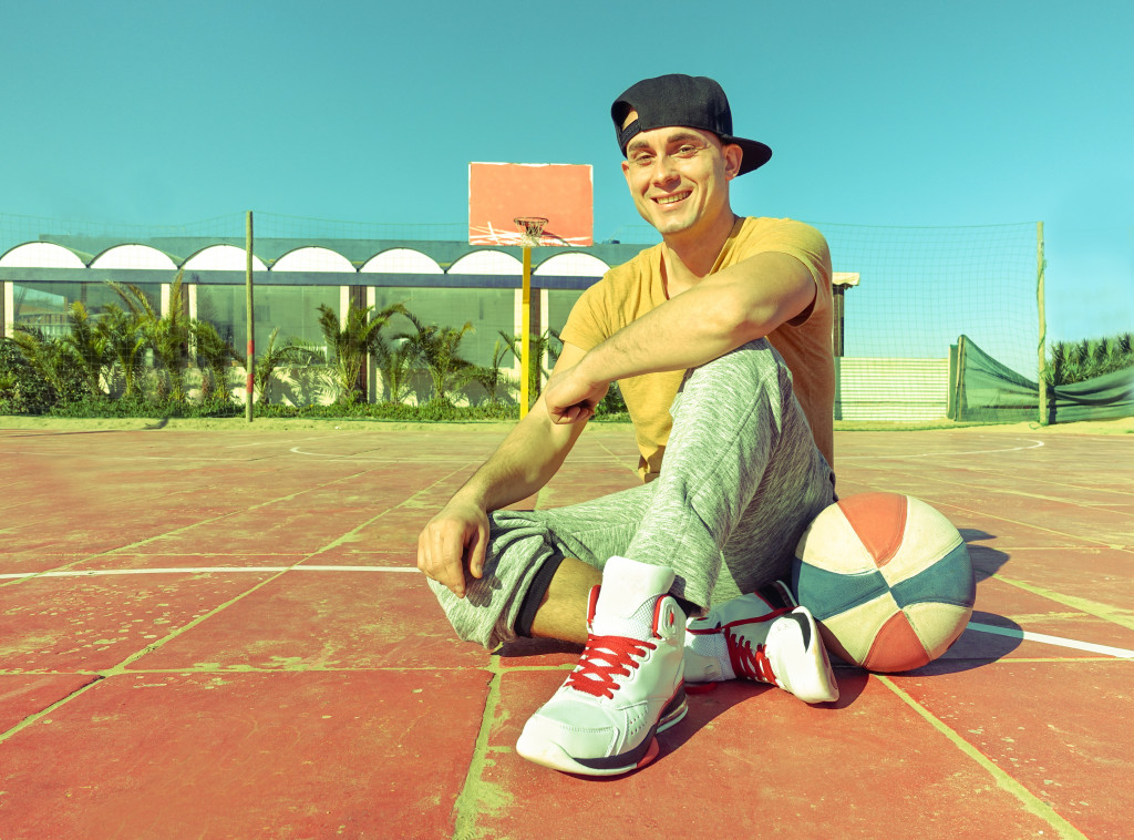 a guy sitting on basketball court