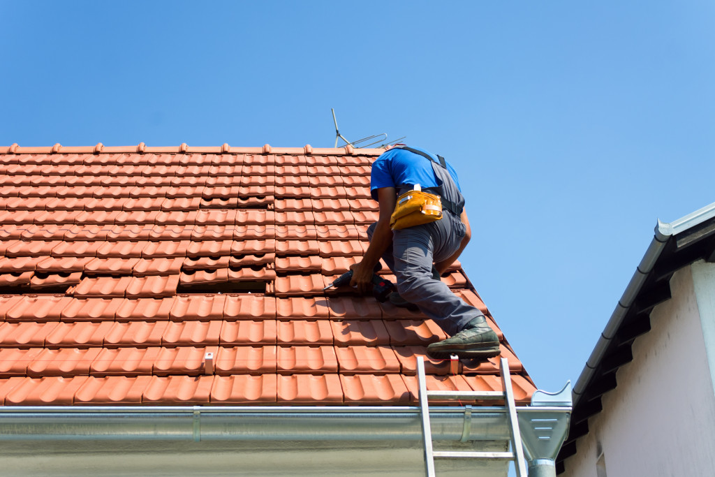 Professional roofer working on the roof of a house.
