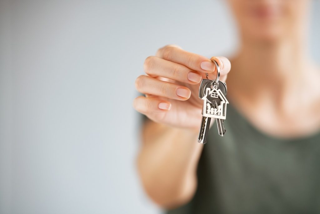 a woman holding house keys